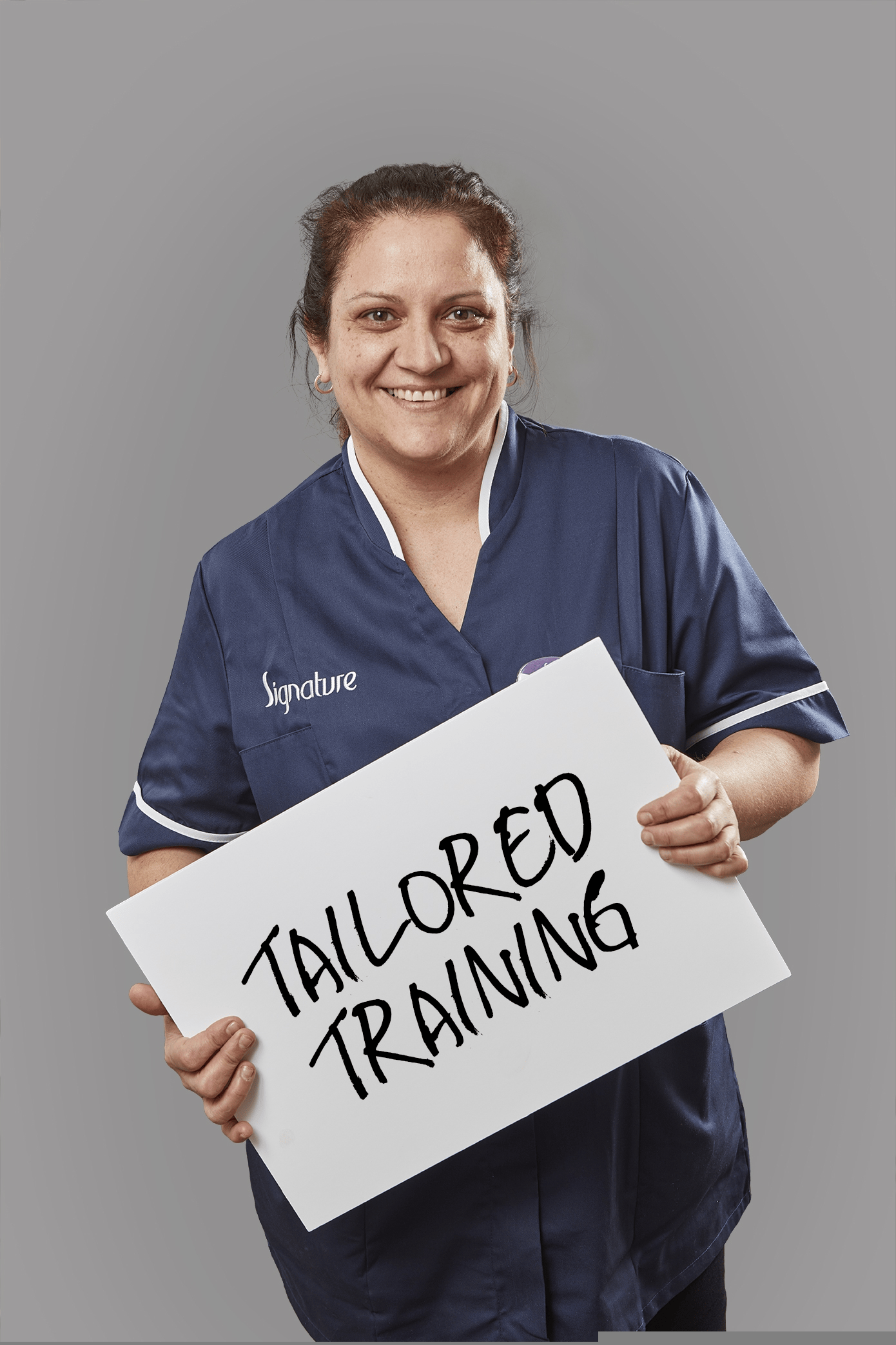 Signature team member holding a tailored training sign