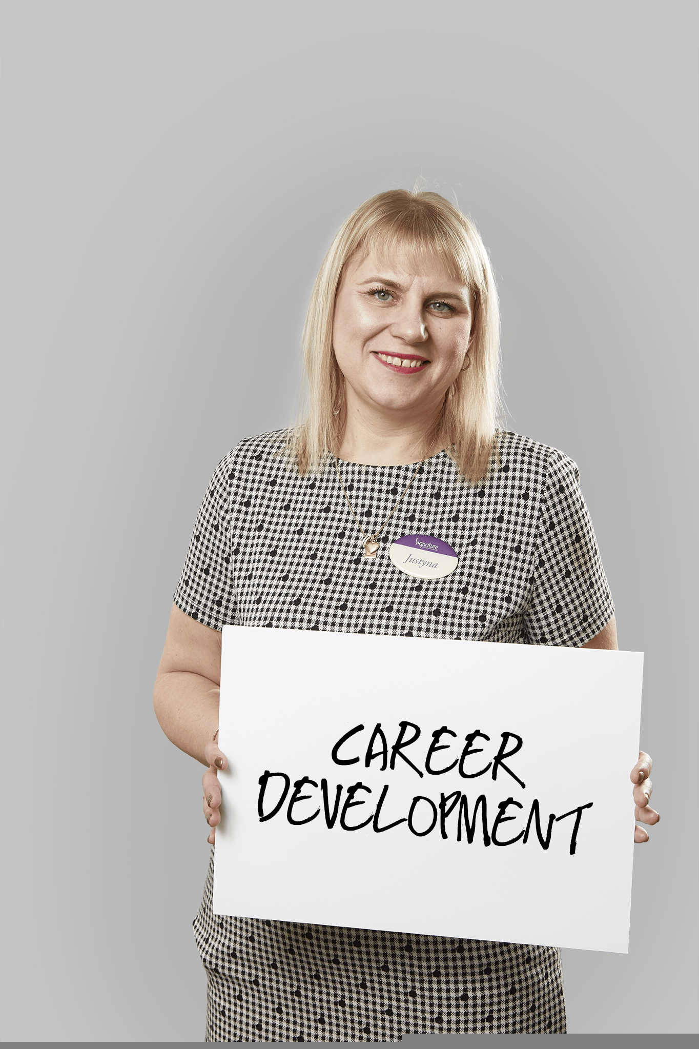 Signature team member holding a career development sign