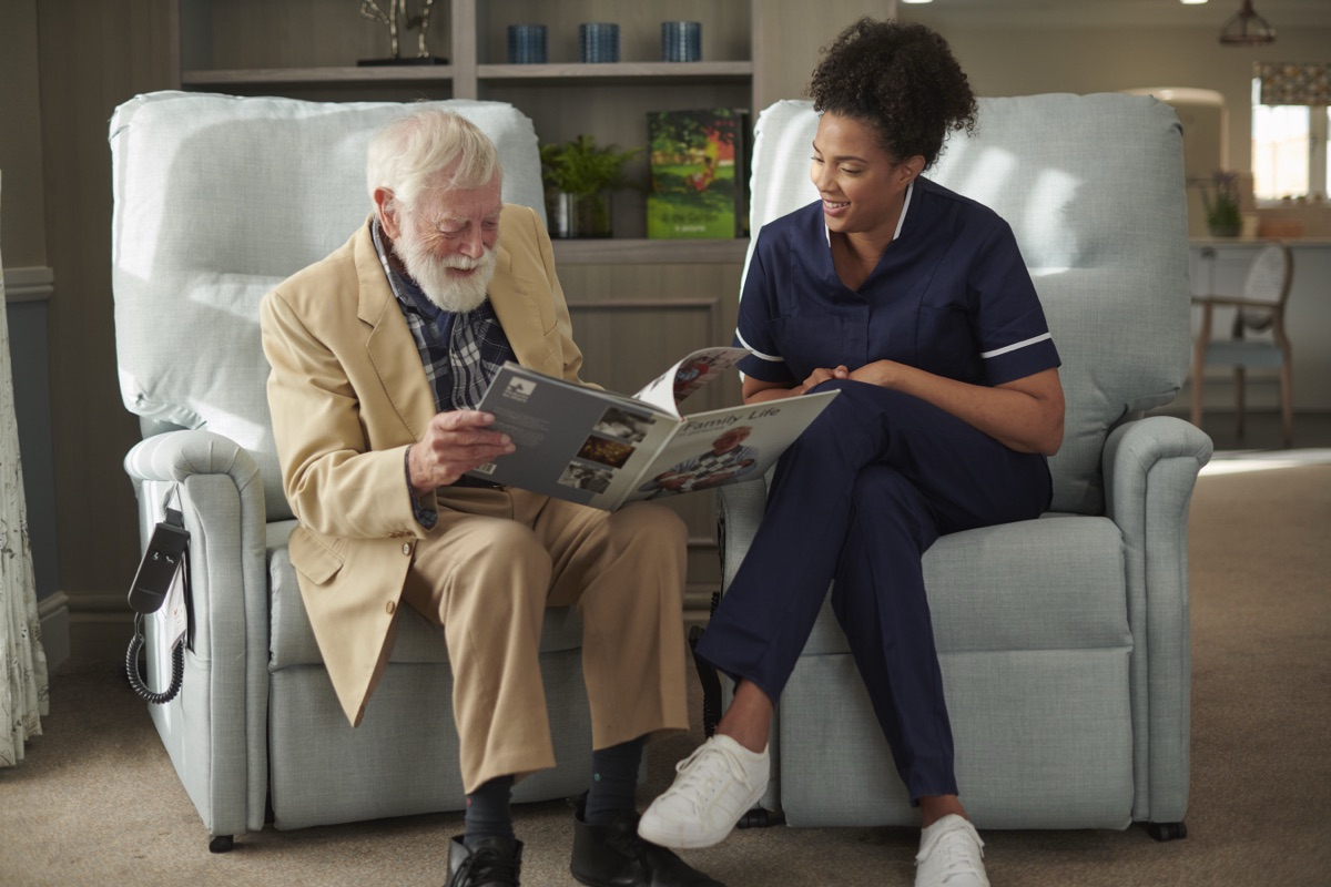 Signature team member reading with a resident